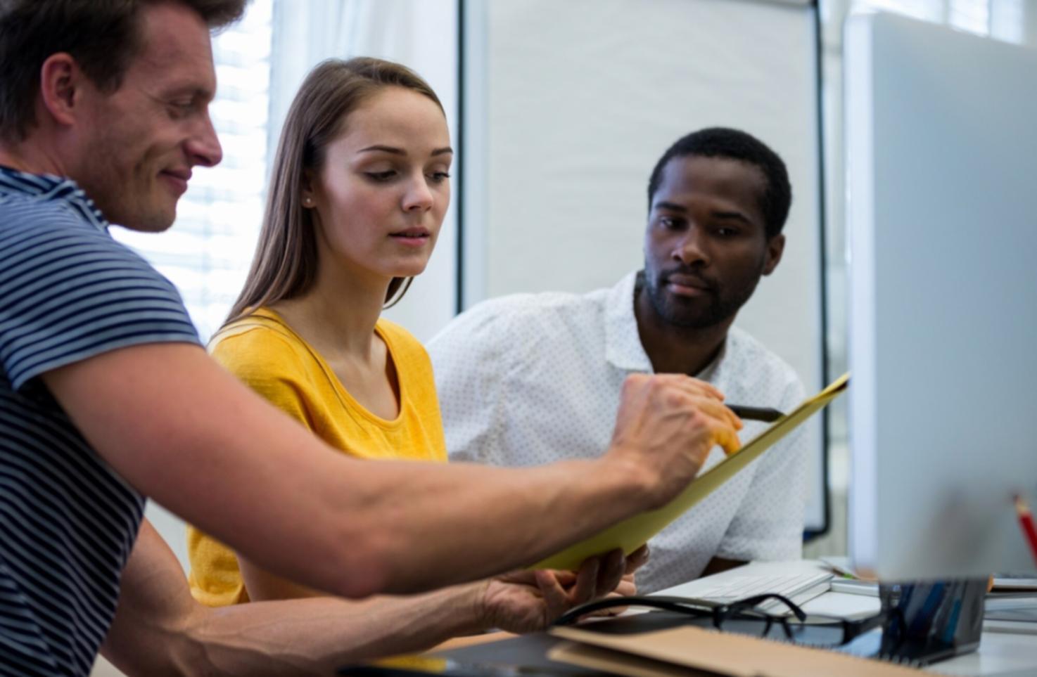 Financial analysts working on complex spreadsheet models